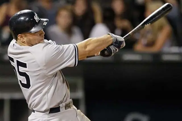 The Yankees' Russell Martin swings on a three-run home run during the ninth inning